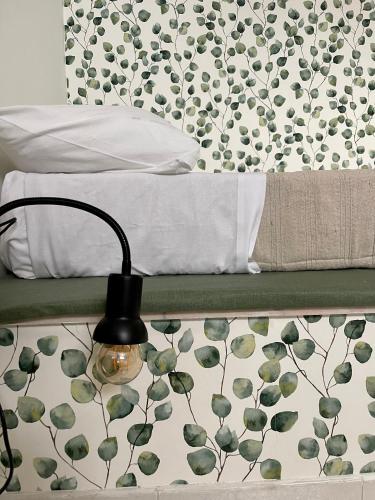 a bedroom with a bed with a lamp next to it at Villa Patty in Marzamemi