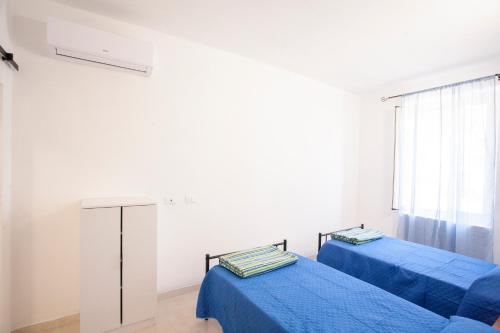 Ένα ή περισσότερα κρεβάτια σε δωμάτιο στο Villetta Capo Bianco - Goelba