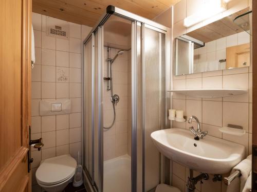a bathroom with a sink and a shower and a toilet at Bauernhof Niederfilzboden in Fieberbrunn