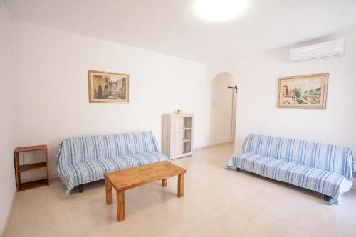 a living room with two couches and a coffee table at Villetta Capo Bianco - Goelba in Portoferraio