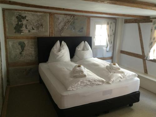 a bed with white sheets and towels on it at Haus in der Zitronengasse in Lindau