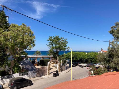 a street with cars parked on the side of the road at SeaSide BayView in Faliraki