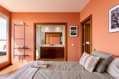 a bedroom with a bed and a bathroom with a sink at Medano Seaview Penthouse CASA CORINA III in El Médano