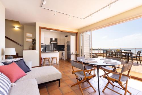 a living room with a couch and a table at Medano Seaview Penthouse CASA CORINA III in El Médano
