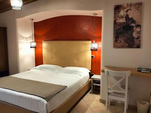 a bedroom with a large bed and a desk at Bed & Breakfast De Nittis in Barletta