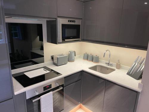 a kitchen with a sink and a microwave at Swan House - 5 x Executive Apartments - Central Bawtry in Bawtry