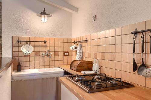 a kitchen with a stove top and a sink at Villa Mala in Umag