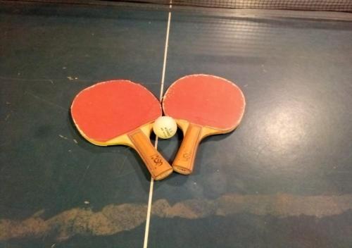 two tennis rackets and a ball on a floor at Hotel Aroma Nainital In house parking in Nainital