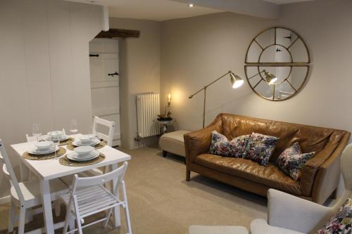 a living room with a couch and a table at The Nook in Bakewell
