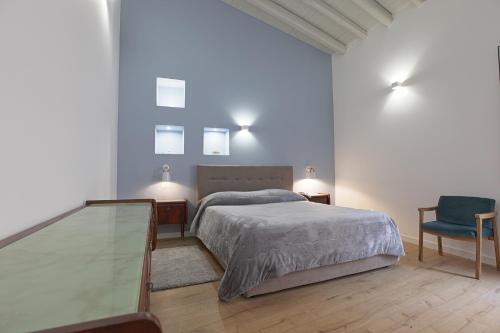 a bedroom with a bed and a glass table at Goethe Dépendance in Agrigento
