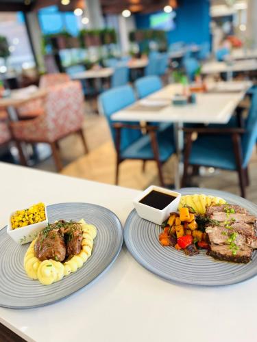 two plates of food sitting on a table at Town Lodge Umhlanga in Durban