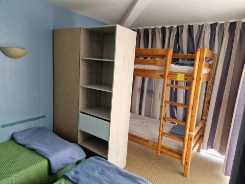 a bedroom with two bunk beds and a ladder at Grand T3 - Terrasse les pieds dans l'eau - Climatisation in Saint-Raphaël