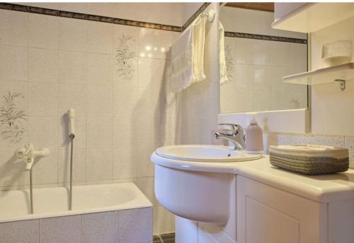 a bathroom with a sink and a toilet and a tub at Villa - Farmhouse in Oropos