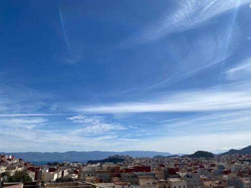 a view of a city under a blue sky at Appartement proche de la corniche in Al Hoceïma