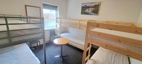 Habitación con 4 literas y mesa. en Holiday Hostel en Reikiavik