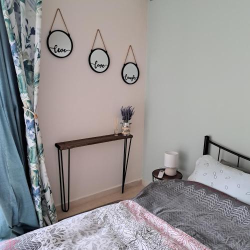 a bedroom with a bed and three mirrors on the wall at Ξενώνας Vasiliki in Vathí