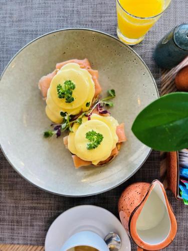 a plate of food with eggs on top of salmon at Town Lodge Umhlanga in Durban