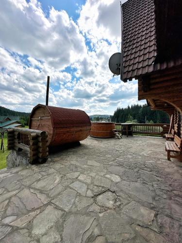 a large wooden boat sitting on top of a patio at Après CHALET in Comandău
