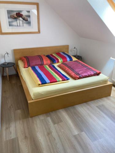 a bed with colorful blankets on it in a room at Ferienwohnung Teichblick -Balkon- in Dresden