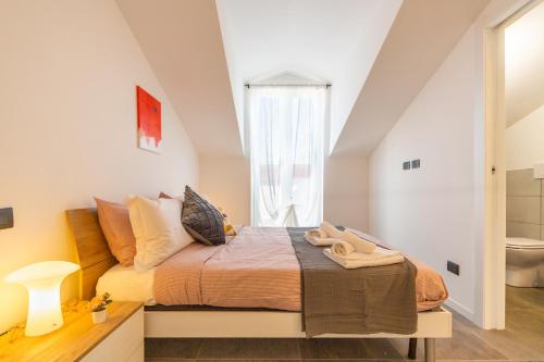 a bedroom with a large bed and a window at KHL APARTMENTS in Milan