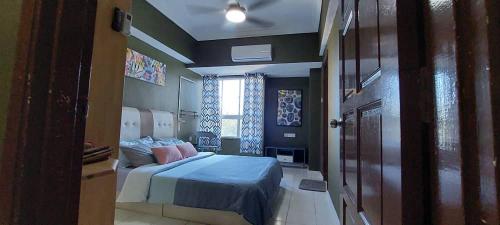 a bedroom with a bed and a window at Adella Homestay Pantai Puteri - 5 min Klebang in Melaka
