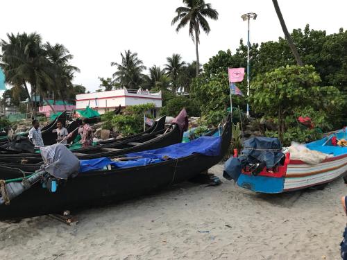 a group of boats sitting on the beach at Gods own home stay in Cochin