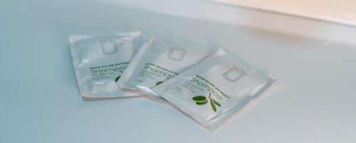 two bags of green cleaning products sitting on a shelf at OPERA16 Guestrooms in Budapest