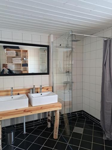 a bathroom with two sinks and a shower at Guesthouse Nature Trails Sweden 