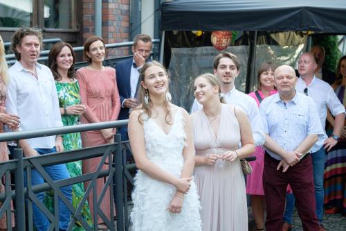 a bride and groom standing in front of a group of people at Hotel Wartosław in Wronki