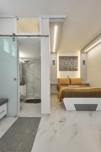 a bedroom with a bed and a bathroom with a shower at Modern Studios for Two in Mytilene