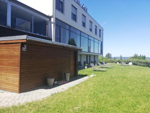 a building with a row of benches in front of it at Das Bergschlösschen in Bamberg