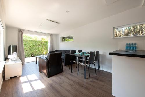 a kitchen and living room with a table and chairs at 54, Prachtige natuur voor fietsers! in Oisterwijk