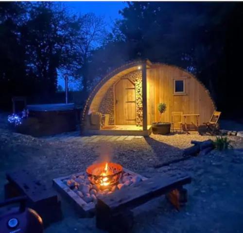 a fire pit in front of a dome house at night at Fox Lodge at Heygates Lodging - with hot tub 