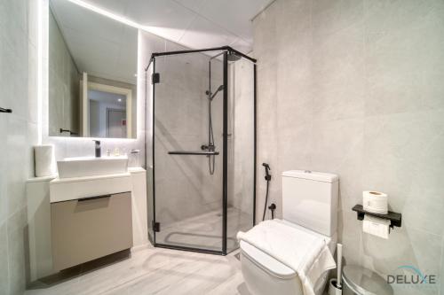 a bathroom with a shower and a toilet and a sink at Classic Studio at Mesk 1 Midtown Dubai Production City by Deluxe Holiday Homes in Dubai