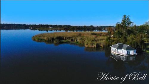 a house on a small island in the middle of a lake at House of Bell - Vaal River in Vanderbijlpark