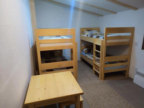 a room with two bunk beds and a table at Vikendica Ribnik 