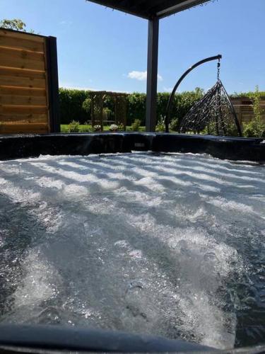 a water park with a roller coaster in the background at The Apple Shed Norfolk in Horsford