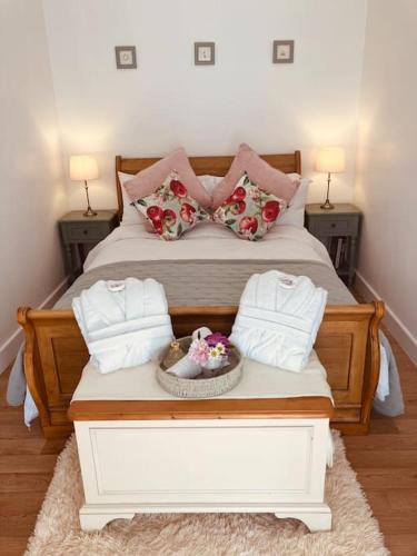 a bedroom with a bed with a bowl of flowers on it at The Apple Shed Norfolk in Horsford