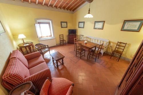 a living room with a couch and a table and chairs at Agriturismo I Bonsi in Reggello