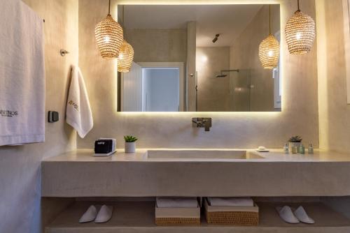 a bathroom with a sink and a large mirror at KaYa Tinos Luxury Villa - Aeolus in Agios Romanos