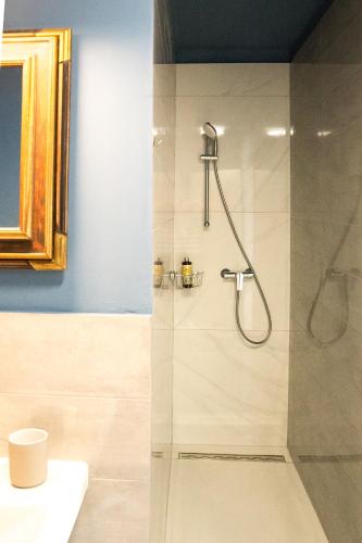 a bathroom with a shower with a glass door at Quiet apartment with a terrace on Organic farm in Prevalje