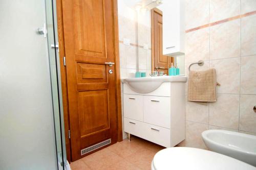 a bathroom with a toilet and a sink and a shower at Villa Lara in Karojba