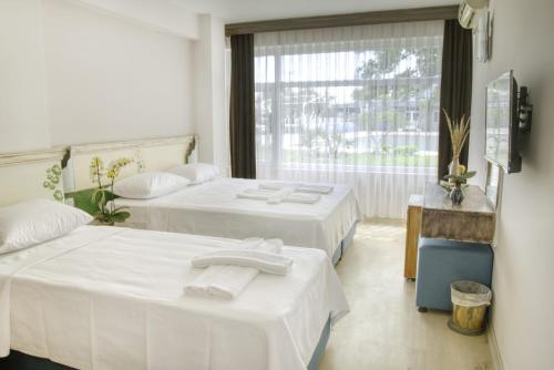 En eller flere senge i et værelse på PEDASOS ALTINEL OTEL