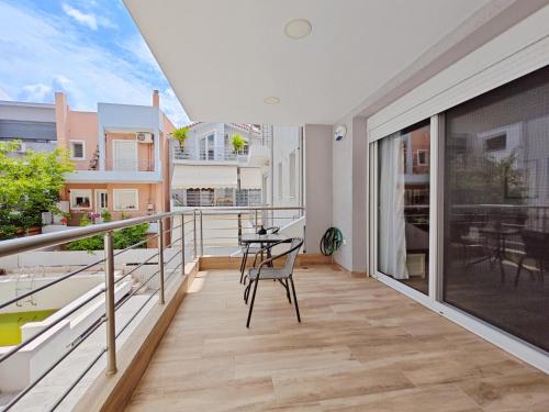 a balcony with a table and chairs on it at Nemeseos Apartments by Verde in Athens