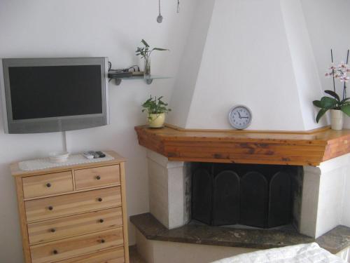 a living room with a tv and a fireplace at Apartments & Room Nina in Korčula
