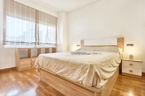 a bedroom with a large bed and a window at Beferent San Juan Pueblo Centro in San Juan de Alicante