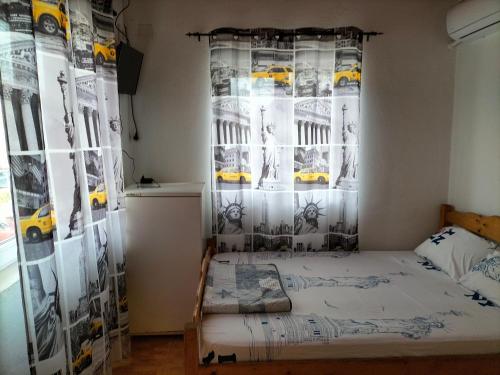 a bedroom with a bed and a curtain with cars at Casa Proto in Costinesti