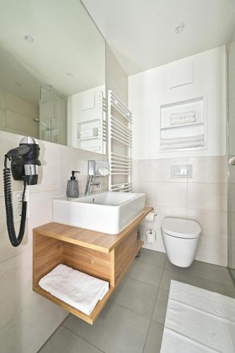 a bathroom with a sink and a toilet at HotelHafenWedel in Wedel