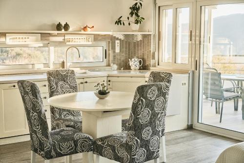 a kitchen with a table and chairs and a table at Mahakala Center in Petrovac na Moru