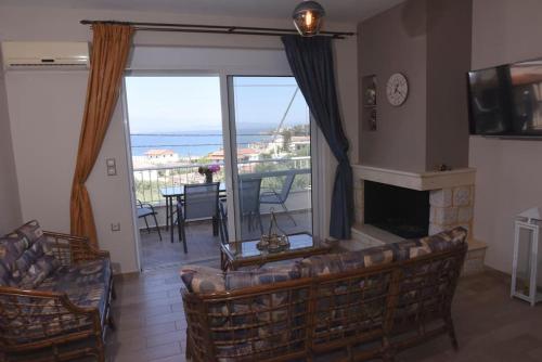 a living room with a couch and a fireplace at Katerina luxury suites in Elia Laconias